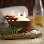 spa experience with candles, oil, and towel