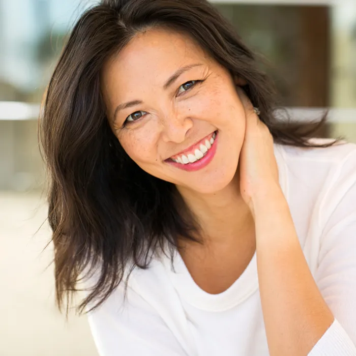 Asian woman laughing and smiling