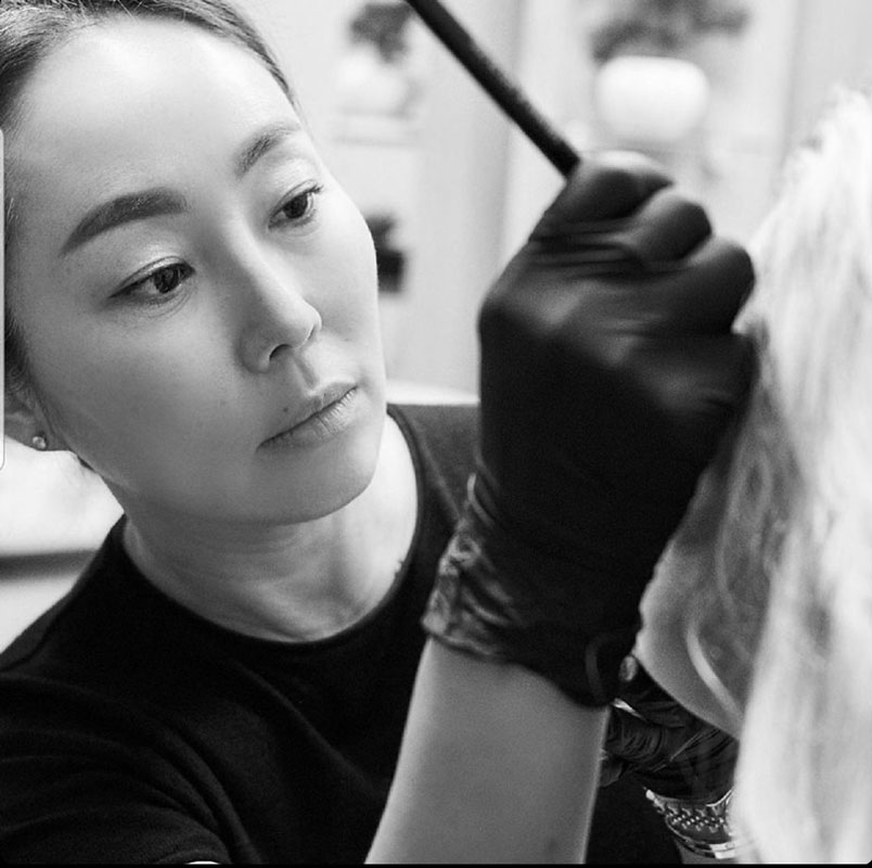 Makeup artist applying cosmetic treatment