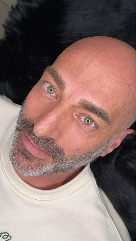 Man with groomed eyebrows lying down